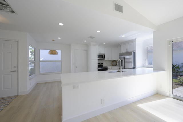 kitchen featuring visible vents, appliances with stainless steel finishes, white cabinets, and a sink