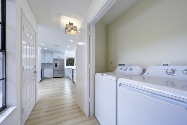 laundry room featuring laundry area, light wood finished floors, recessed lighting, and washer and dryer