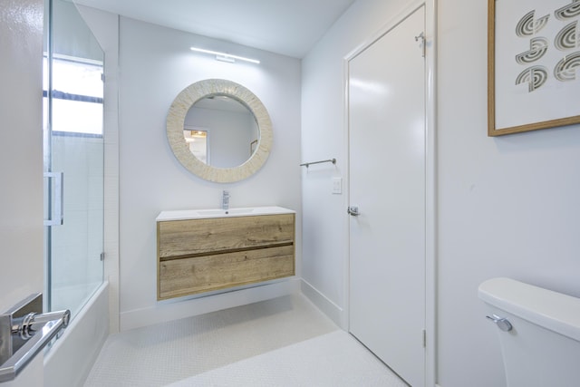 bathroom with toilet, enclosed tub / shower combo, and vanity