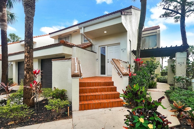 exterior space featuring an attached garage and stucco siding