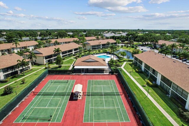 surrounding community featuring a yard, a water view, and view of golf course