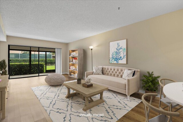 unfurnished living room with a textured ceiling, a sink, visible vents, stacked washer / drying machine, and light wood finished floors