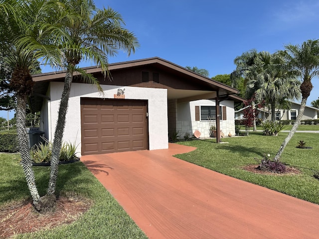 3482 Amalfi Dr, West Palm Beach, FL 33417 - view of front of home with stucco siding, driveway, a front lawn, and a garage