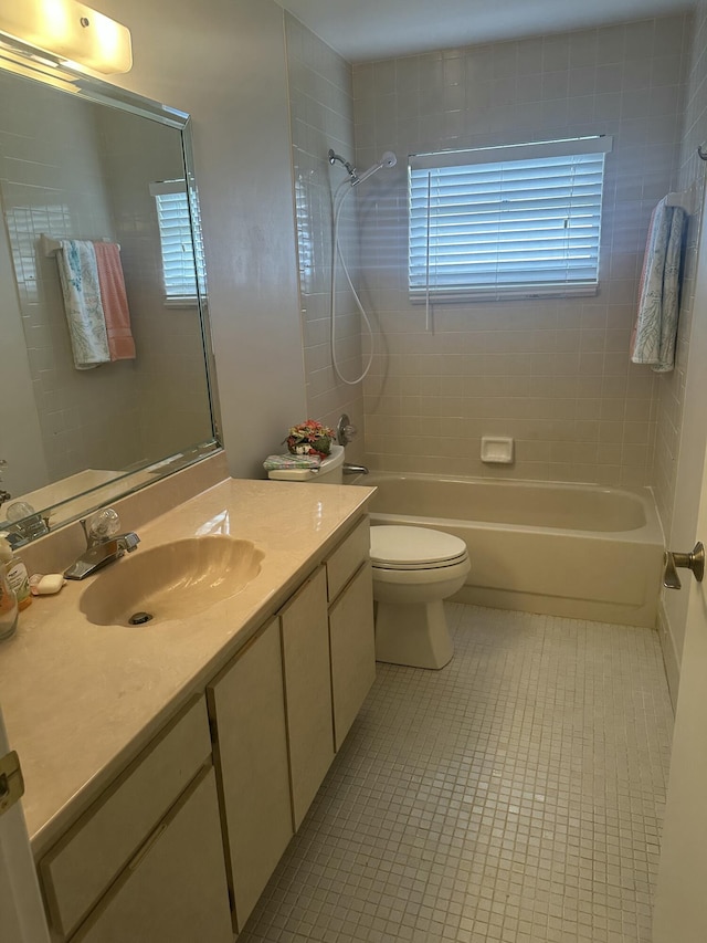 full bathroom with vanity, tile patterned floors, toilet, and tiled shower / bath