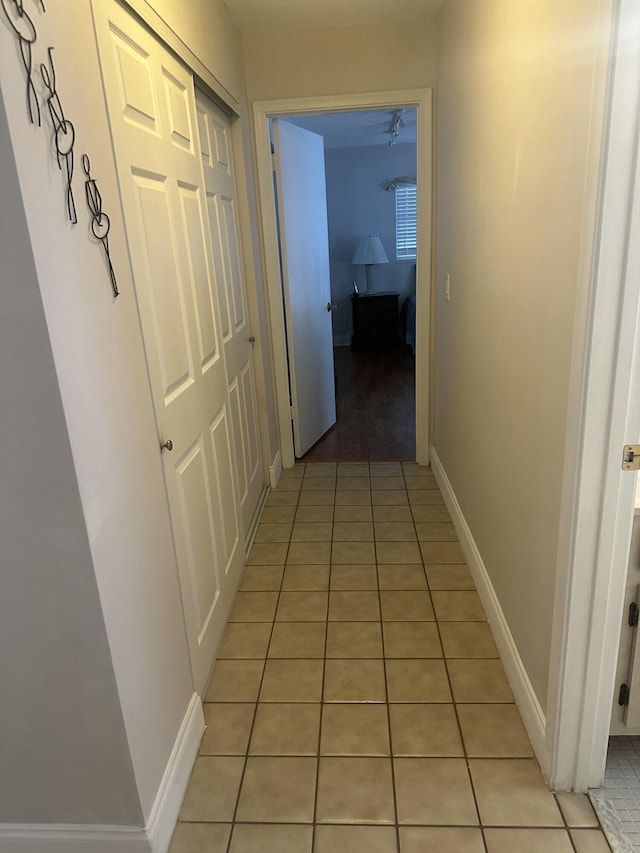 corridor featuring light tile patterned flooring