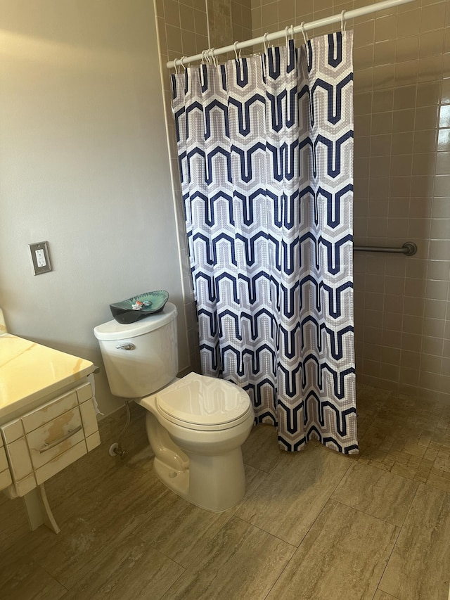 bathroom with vanity, toilet, curtained shower, and hardwood / wood-style floors