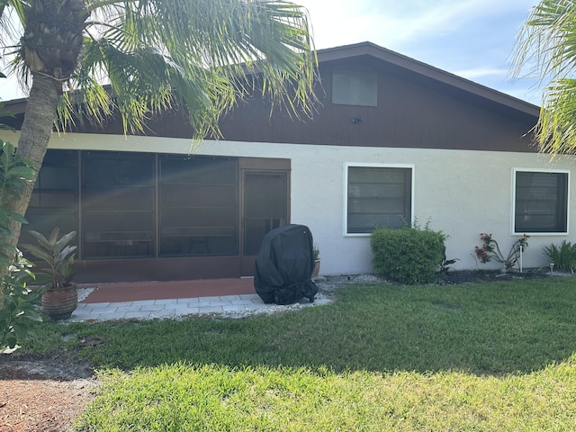 3482 Amalfi Dr, West Palm Beach, FL 33417 - back of house with a sunroom, a yard, and stucco siding