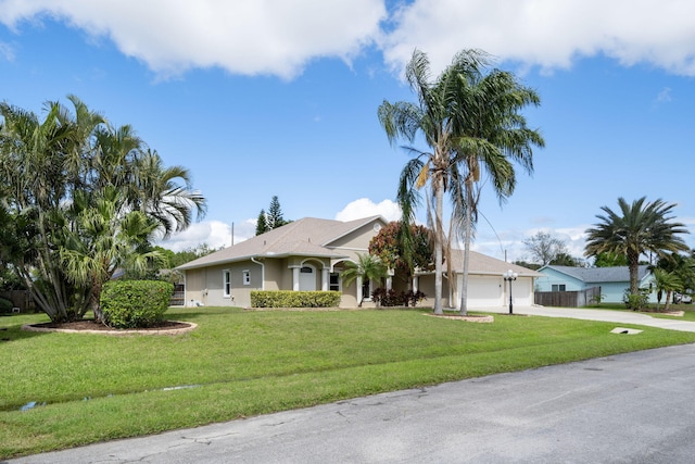 ranch-style house featuring driveway, a front lawn, an attached garage, and stucco siding