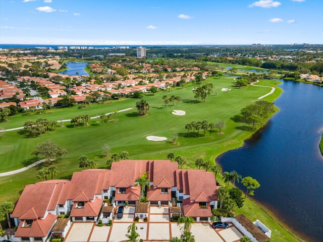 bird's eye view with golf course view, a water view, and a residential view