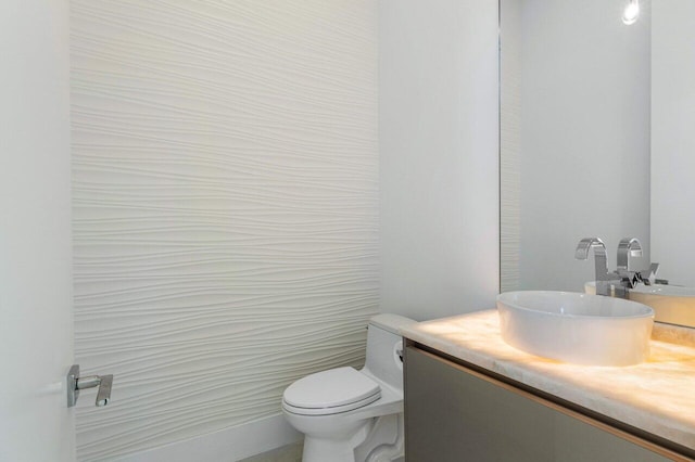 bathroom featuring toilet and vanity