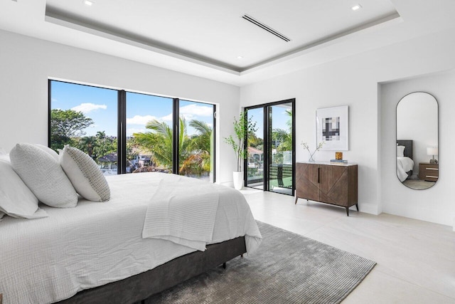 bedroom with access to outside, a raised ceiling, visible vents, and baseboards