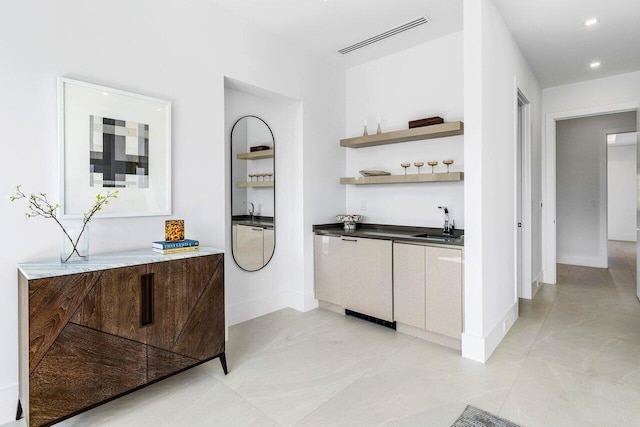 bar with recessed lighting, a sink, visible vents, and baseboards