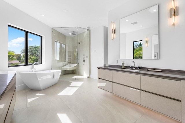 bathroom featuring a freestanding bath, tile patterned flooring, a shower stall, and vanity