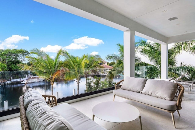 sunroom / solarium featuring a water view