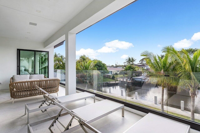 interior space with a water view and an outdoor living space