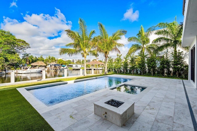 outdoor pool with a water view, an outdoor fire pit, and a patio