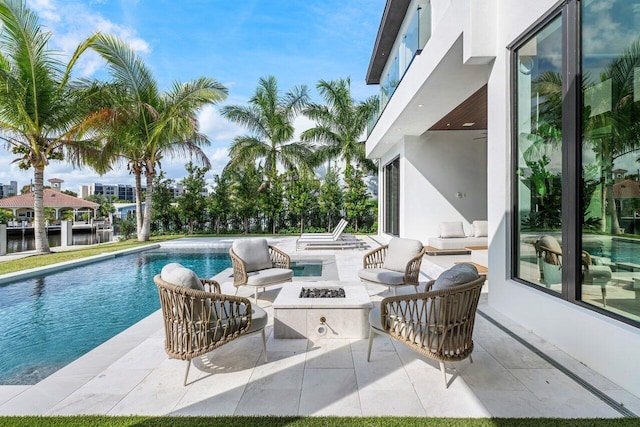 pool featuring a fire pit and a patio