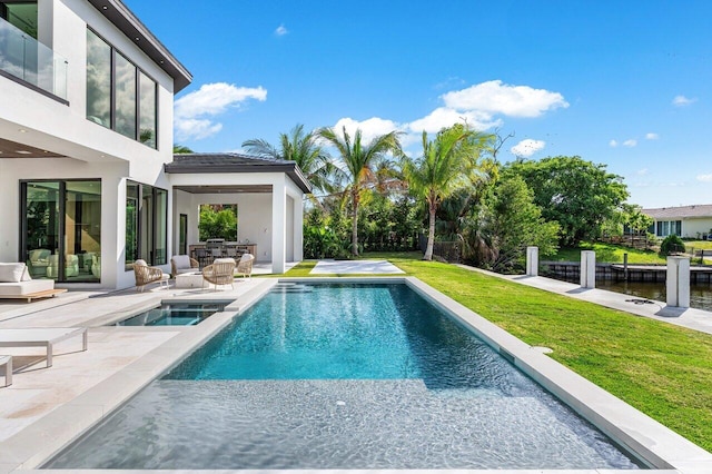 view of swimming pool with a patio area, a fenced in pool, a lawn, and an in ground hot tub