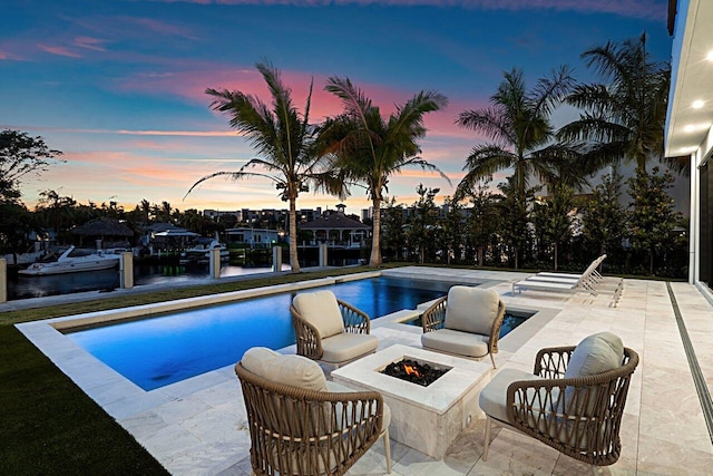 pool featuring a patio area and a fire pit