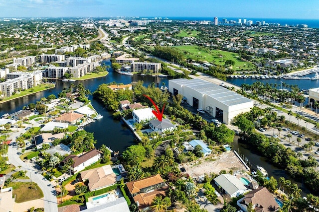 drone / aerial view featuring a view of city and a water view