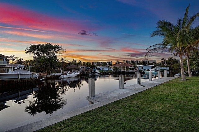 dock area featuring a yard and a water view