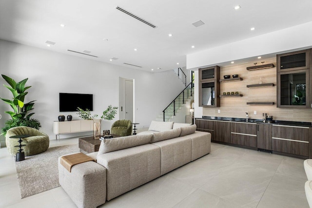 living room with recessed lighting, visible vents, and stairway