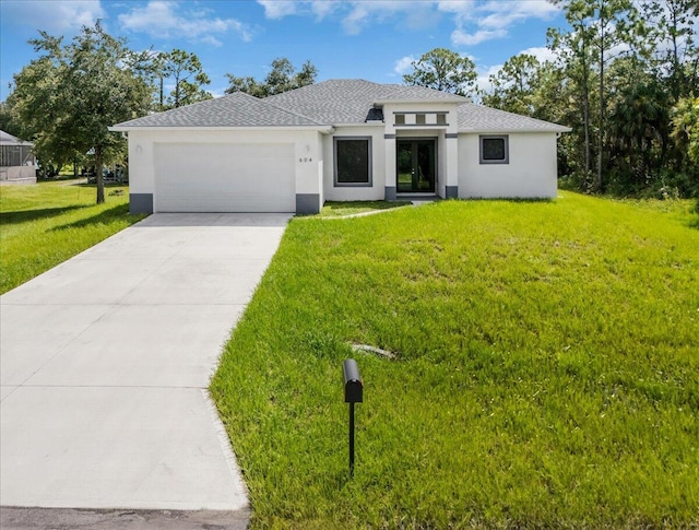 view of front of home with a front yard and a garage