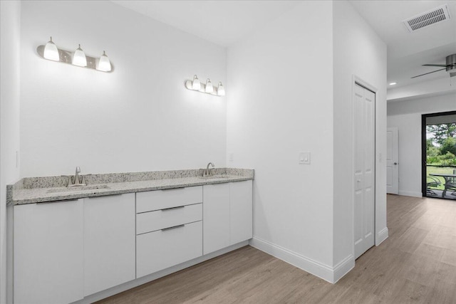 604 Lake Ave, Lehigh Acres, FL 33972 - bathroom featuring ceiling fan, wood-type flooring, and vanity