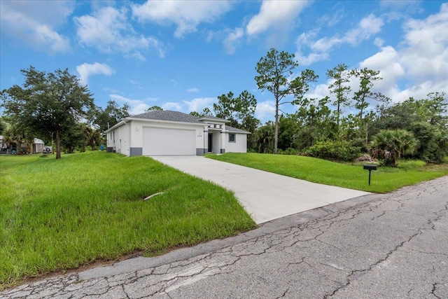 view of front of house with a front yard and a garage