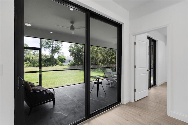 604 Lake Ave, Lehigh Acres, FL 33972 - doorway to outside featuring ceiling fan and light hardwood / wood-style flooring