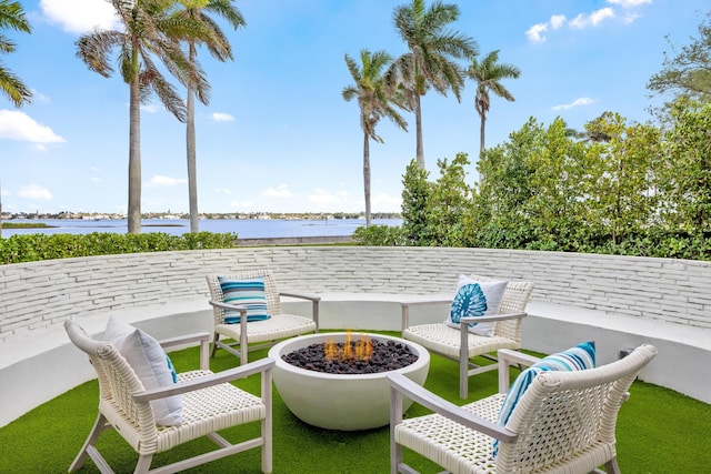 view of patio / terrace featuring a fire pit and a water view