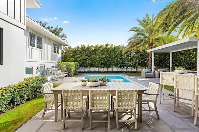 view of swimming pool featuring an outdoor living space and a patio area