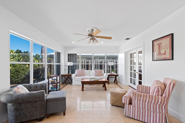 living room featuring light tile patterned flooring, french doors, and ceiling fan