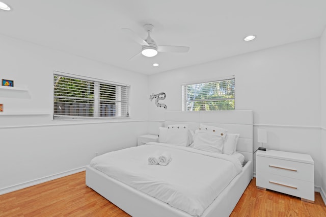 bedroom with ceiling fan and light hardwood / wood-style floors