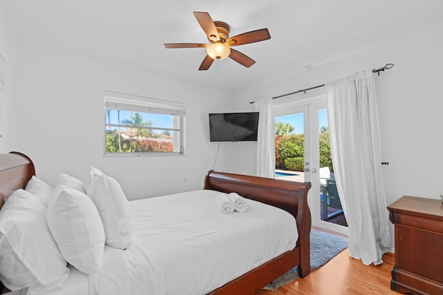 bedroom featuring light hardwood / wood-style floors, access to outside, multiple windows, and french doors