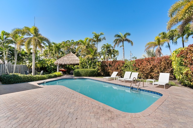 view of swimming pool featuring a fenced in pool, a patio area, and fence