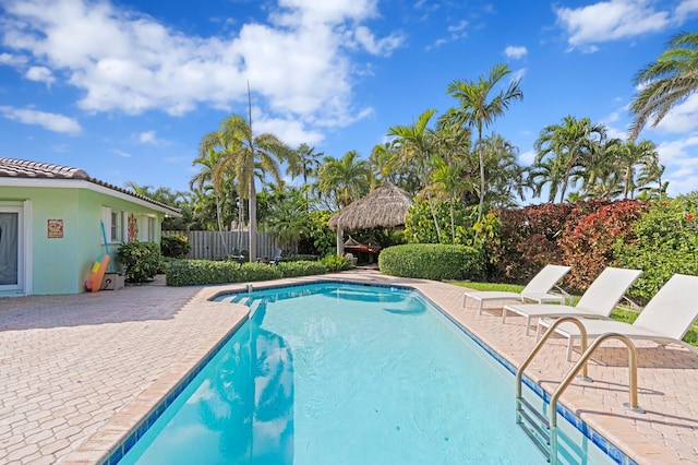 view of swimming pool featuring a fenced in pool, a patio area, fence, and a gazebo
