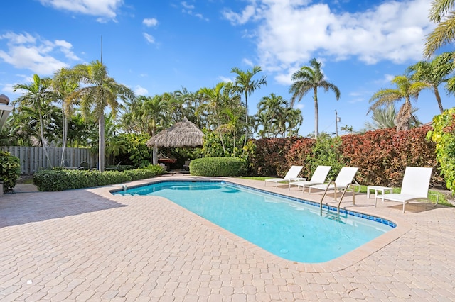 view of swimming pool with a patio area, fence, a fenced in pool, and a gazebo