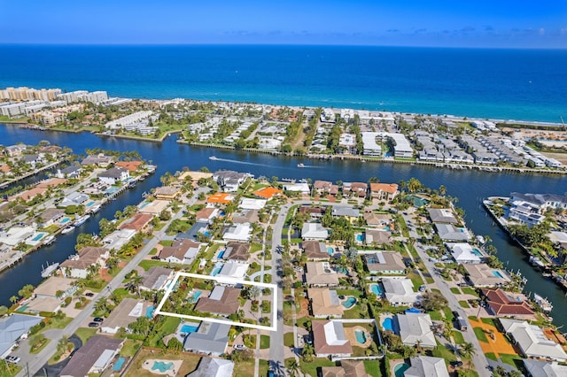 drone / aerial view featuring a water view and a residential view