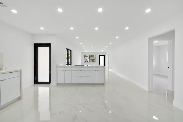 interior space with recessed lighting, visible vents, white cabinetry, marble finish floor, and modern cabinets