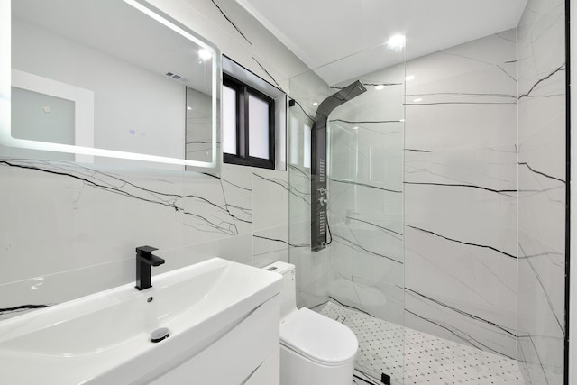 full bathroom with a marble finish shower, visible vents, toilet, vanity, and tile walls