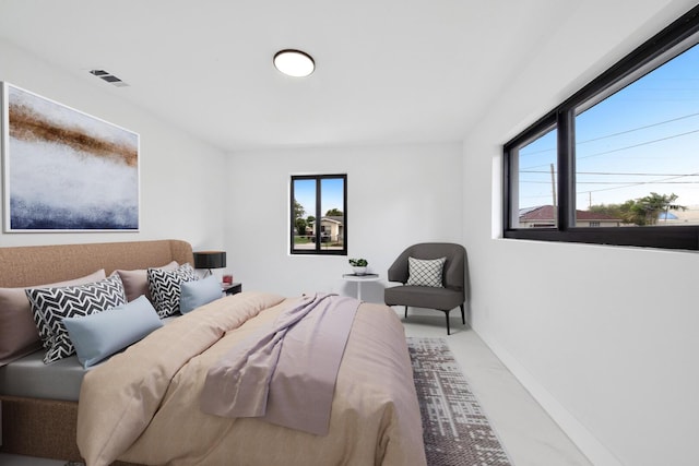 carpeted bedroom featuring multiple windows, visible vents, and baseboards