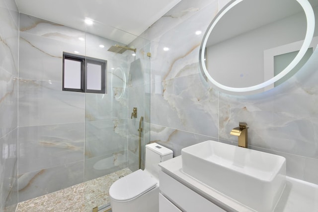 bathroom with toilet, walk in shower, tile walls, and vanity