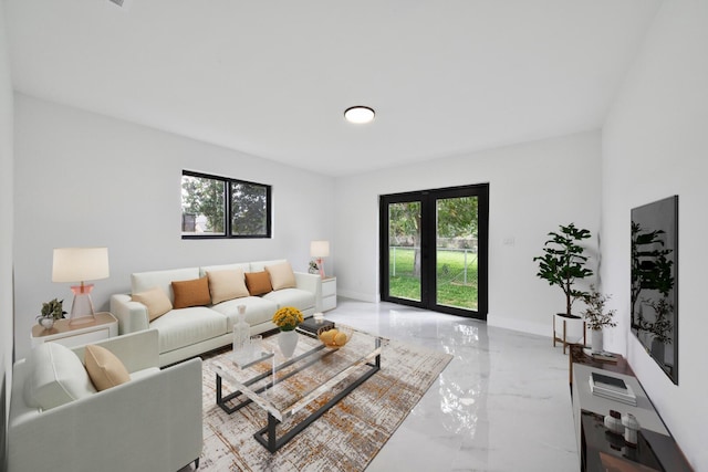 living area with marble finish floor, plenty of natural light, and baseboards