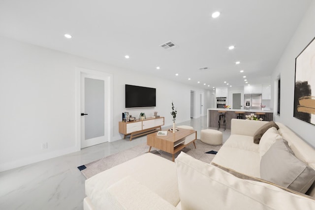 living area with marble finish floor, baseboards, visible vents, and recessed lighting