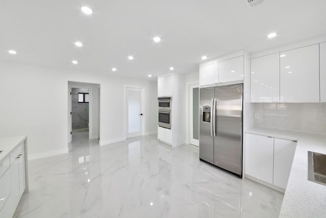 kitchen with recessed lighting, stainless steel appliances, white cabinets, marble finish floor, and modern cabinets