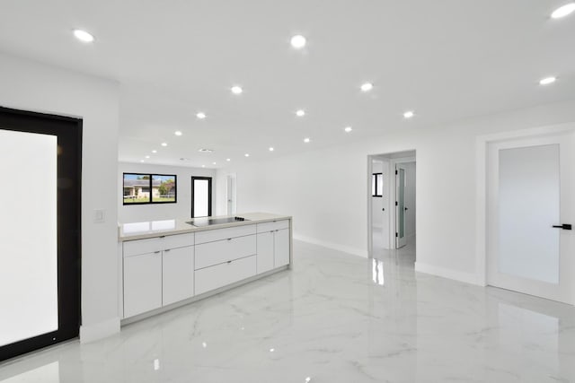 kitchen featuring marble finish floor, black electric stovetop, recessed lighting, white cabinetry, and modern cabinets