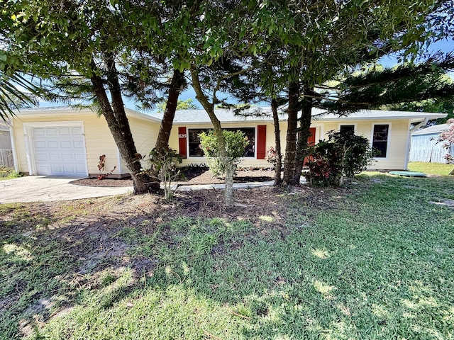 ranch-style home with a garage and a front yard