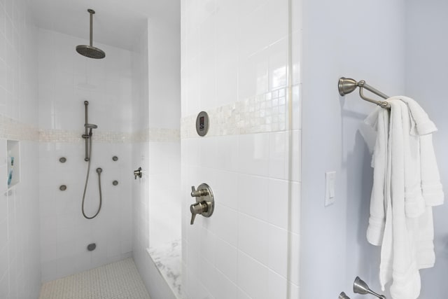 bathroom with a tile shower