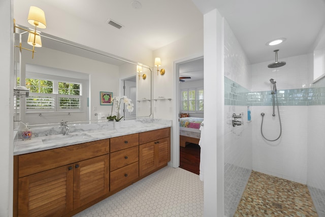 bathroom with vanity and a tile shower